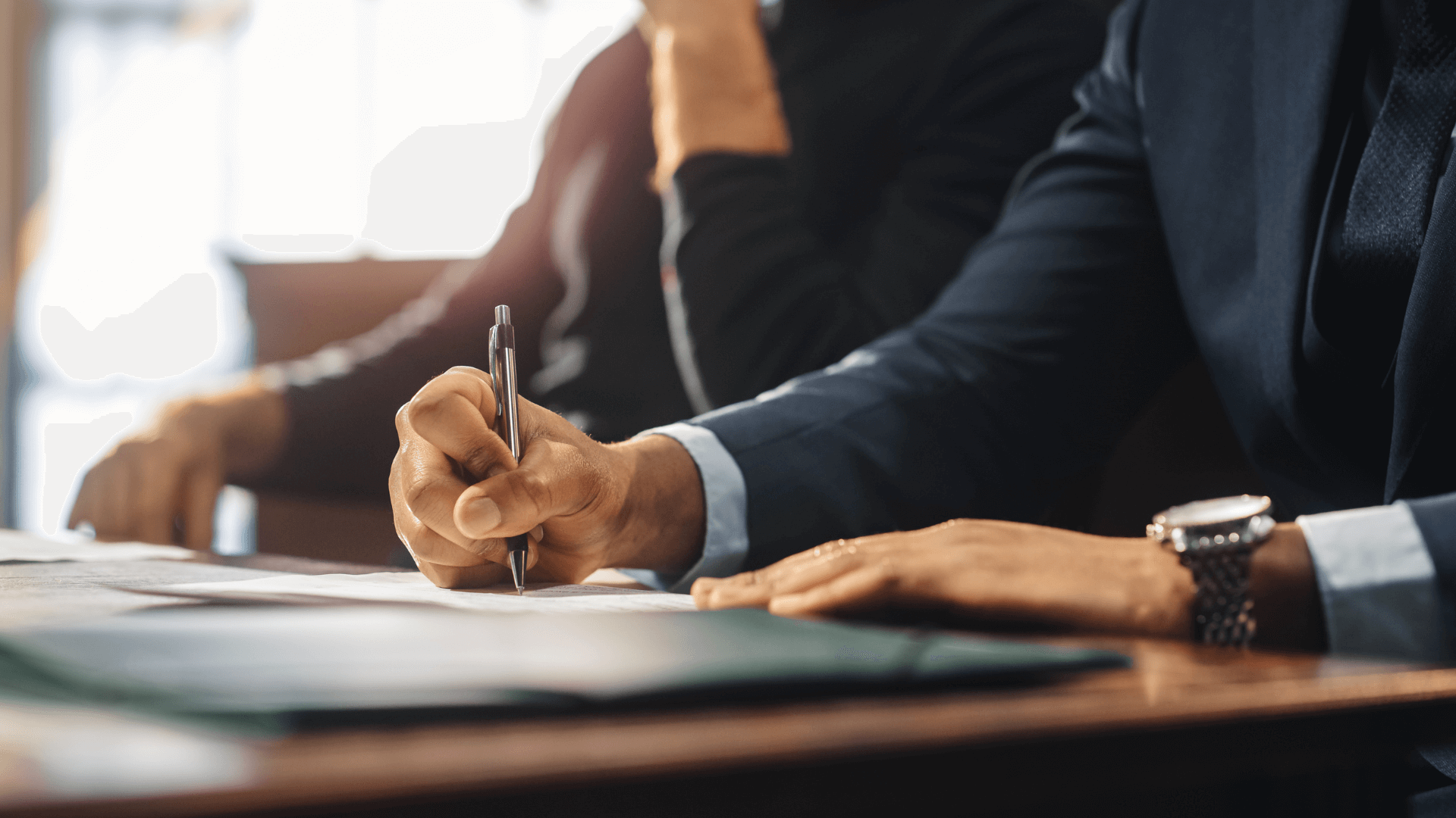 Lawyer writing down notes on a piece of paper