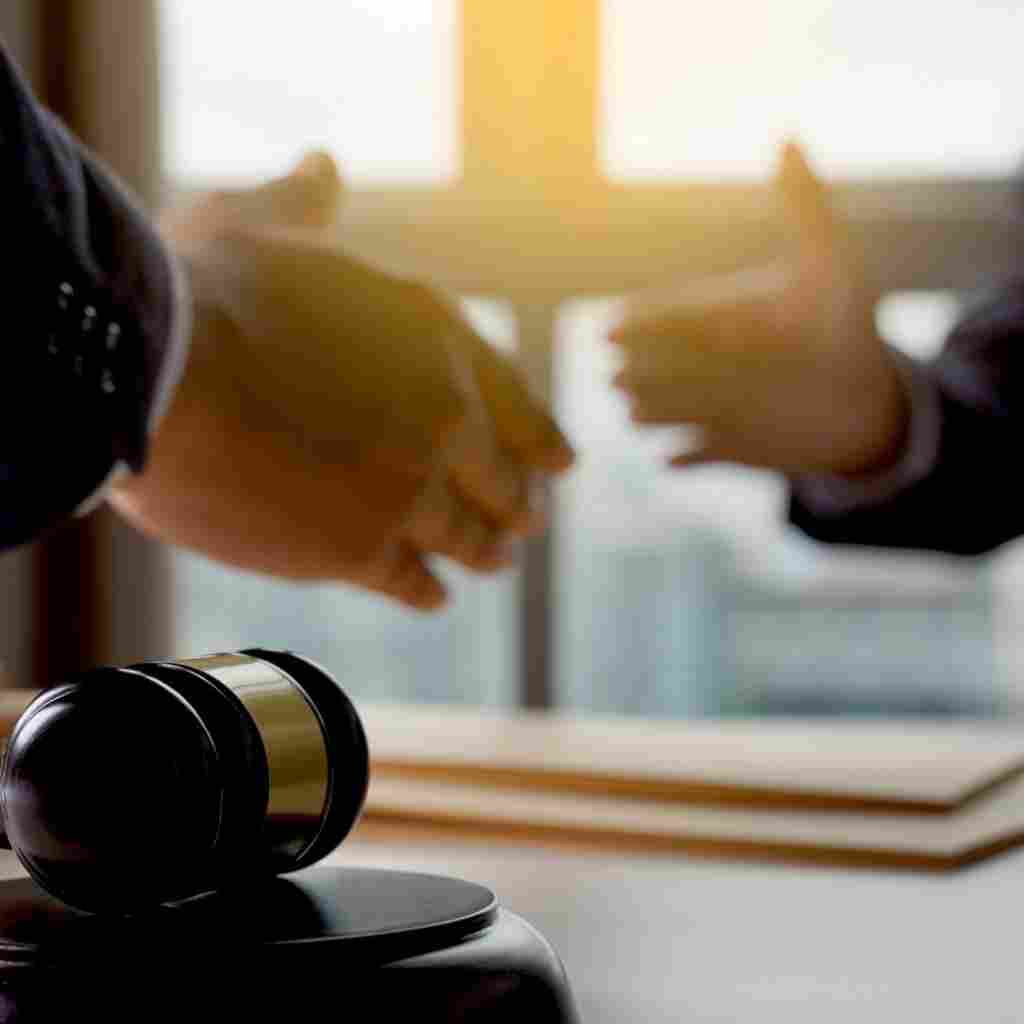 An attorney speaking with a client at his desk