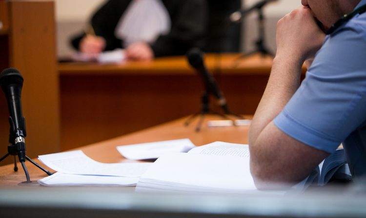 Defendant of drug charges sitting in a courtroom